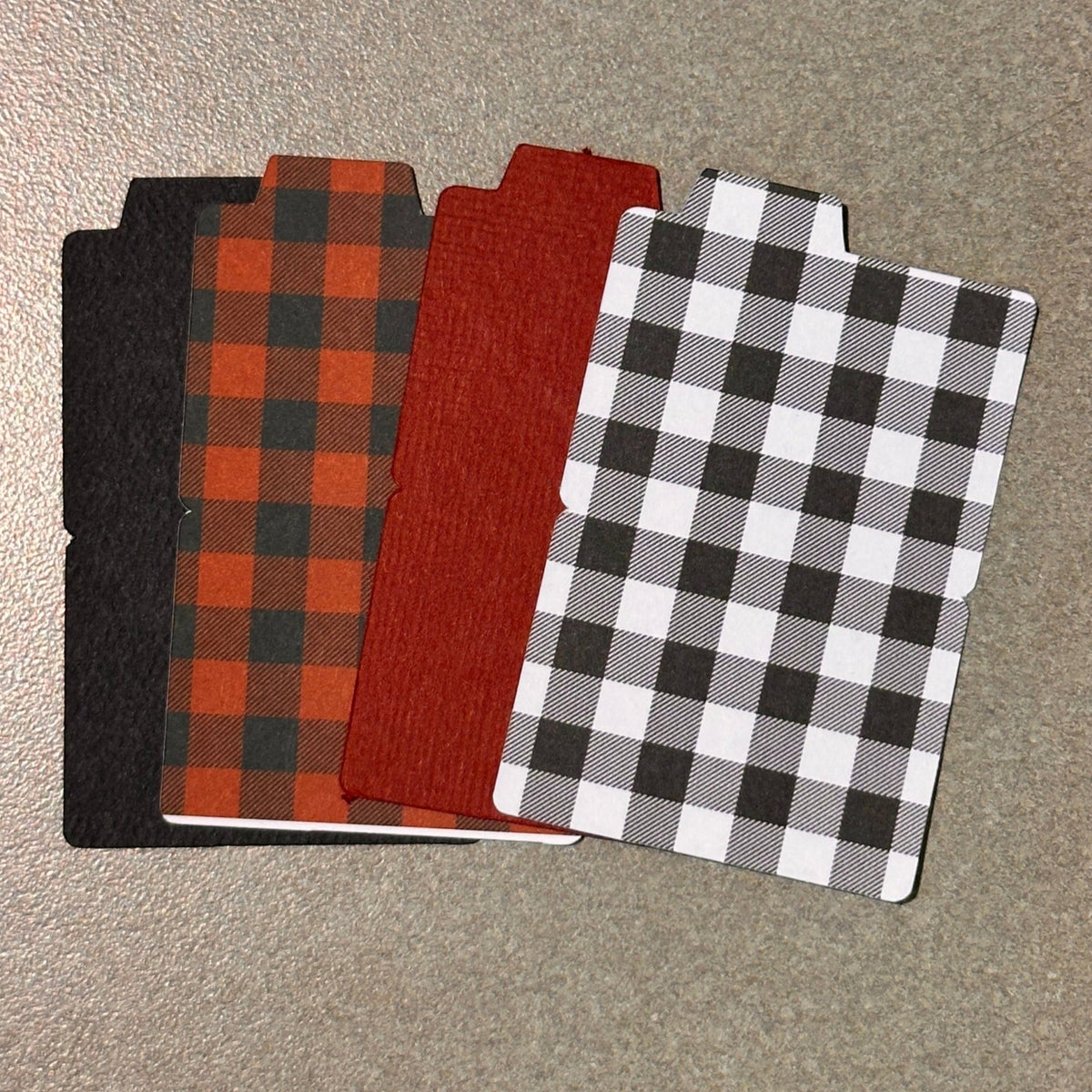 A collection of mini file folders in various solid colors displayed on a surface.
