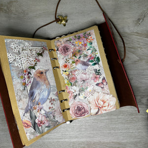 Butterfly embossed woman on red journal with completed pages