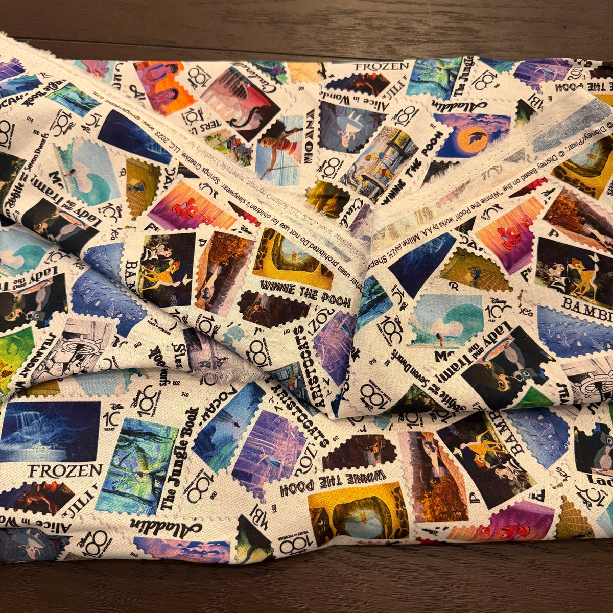 Disney 100 Years of Wonder Postage Stamp fabric - by the 1/4 yard