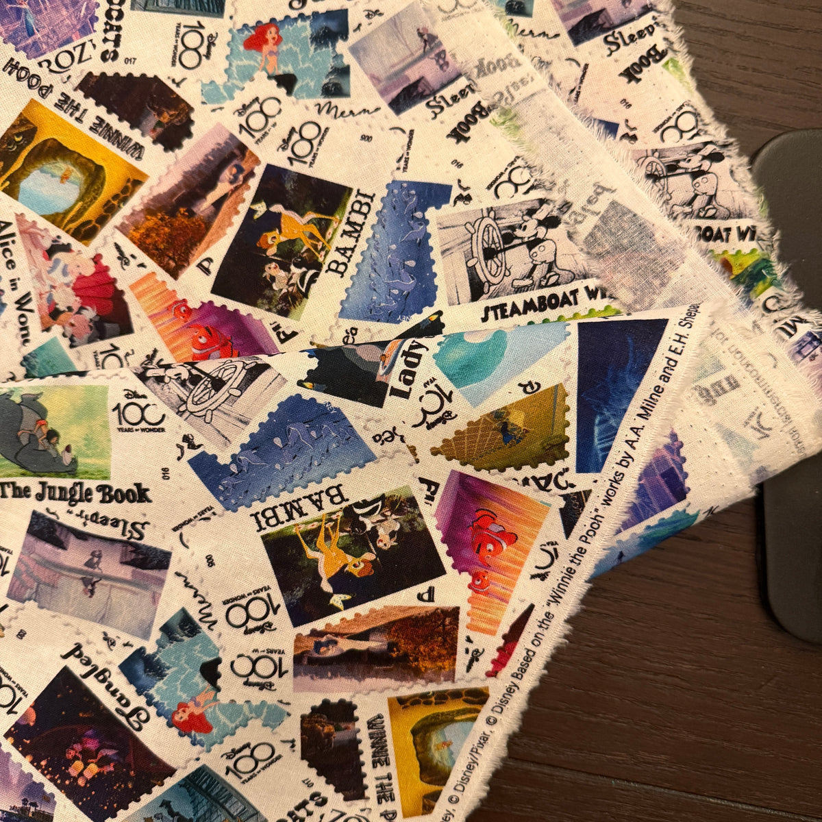 Disney 100 Years of Wonder Postage Stamp fabric - by the 1/4 yard